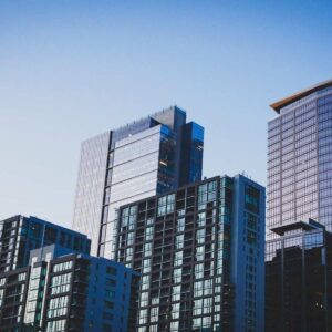 white and blue glass walled high rise building